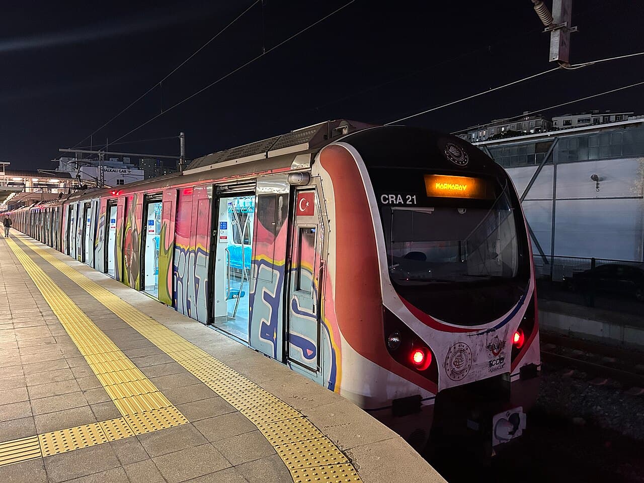 Marmaray commuter train waiting at a platform, the cross-Bosphorus rail line used for both airport routes